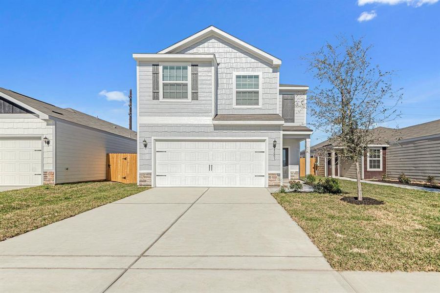 This beautiful two-story features a modern exterior design with beautiful LP siding and stone.