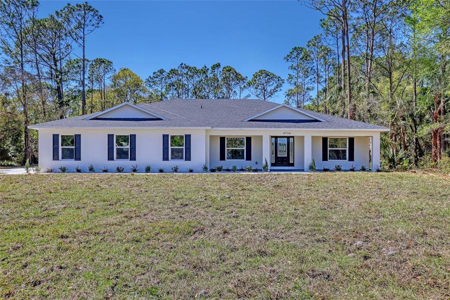Front exterior of a new home in , Mims, FL, highlighting curb appeal (Image 23).