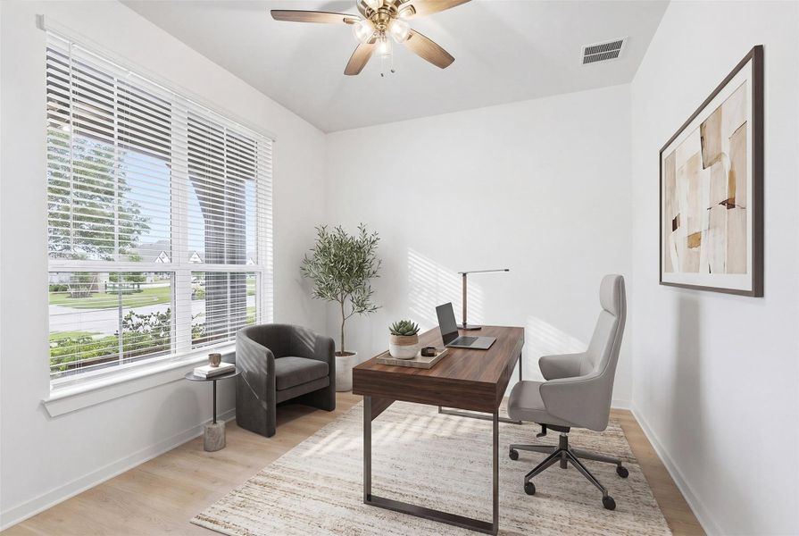 This beautifully designed home office showcases rich wood flooring, sun-filled windows with privacy blinds, and a ceiling fan for added comfort, creating the perfect blend of style and functionality for working from home. *virtually staged