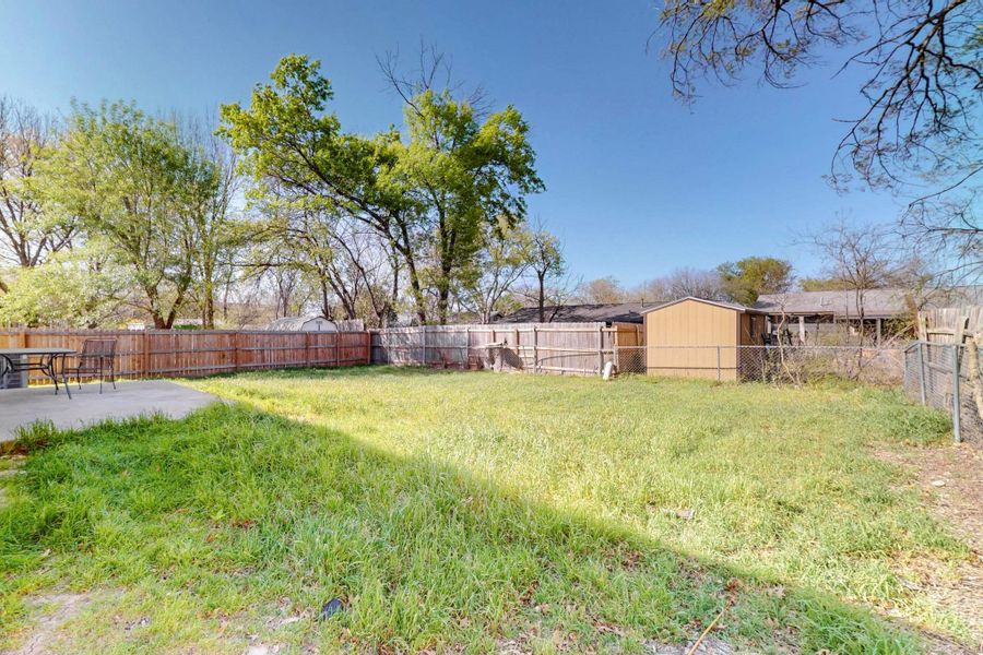 View of yard with a fenced backyard and a patio area