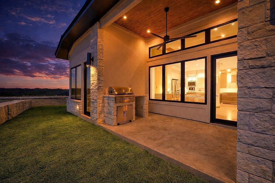View of patio featuring an outdoor kitchen and ceiling fan