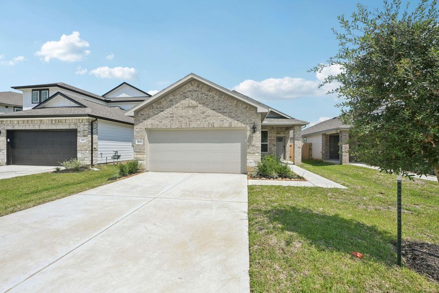 Front exterior of a new home in Landing Meadows - Traditional Series, New Caney, TX, highlighting curb appeal (Image 23).