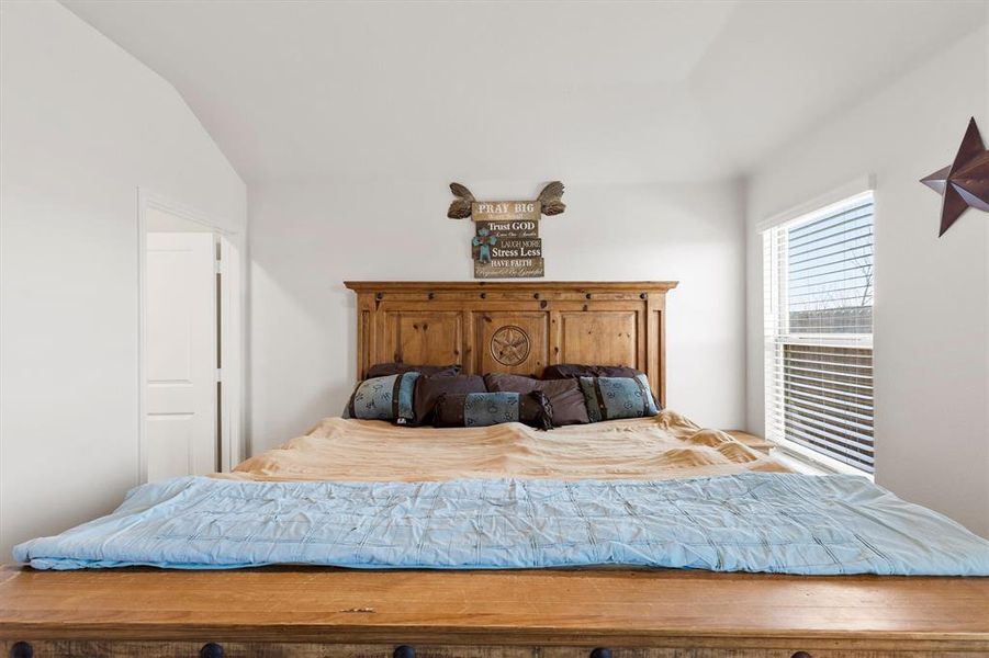 Bedroom featuring vaulted ceiling Bedroom featuring vaulted ceiling