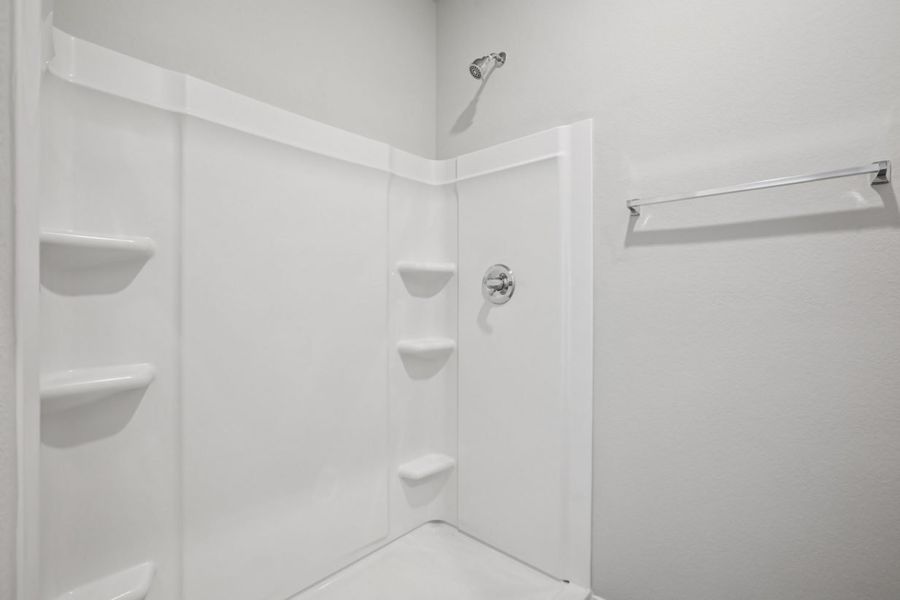 Image of a walk-in shower with white shelves