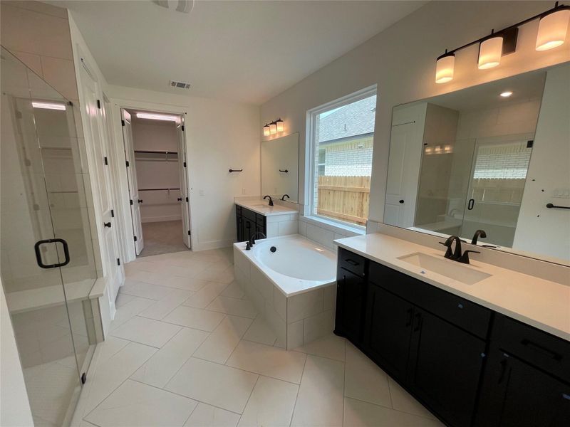 Primary Bath retreat with dual vanities, garden tub & walk-in shower Primary Bath retreat with dual vanities, garden tub & walk-in shower