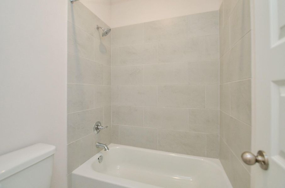 Notice the shower/tub combination and the beautiful tile wall. Notice the shower/tub combination and the beautiful tile wall.