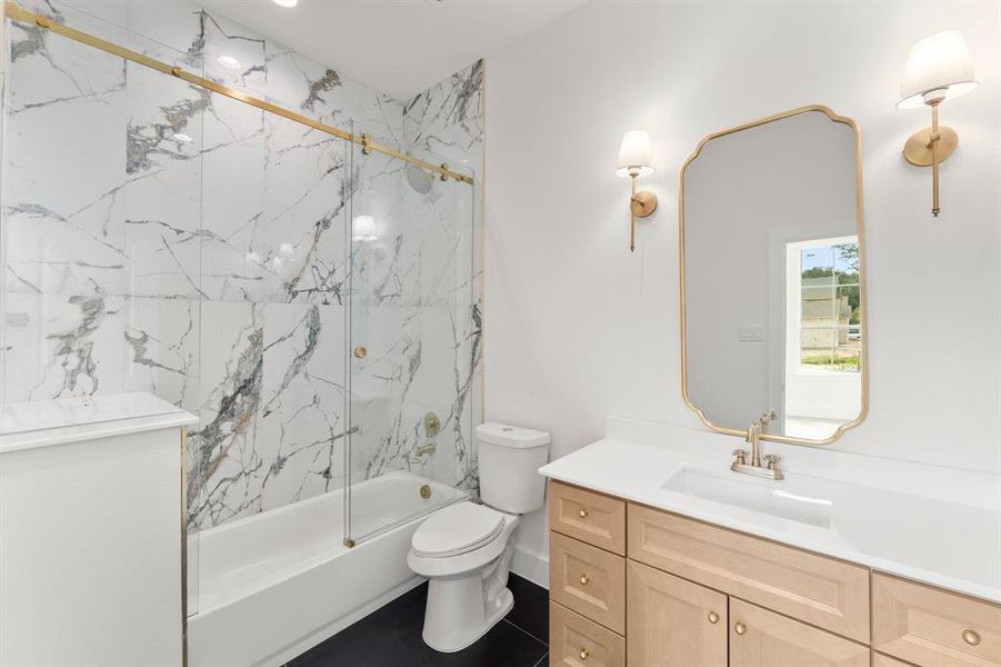 Full bath with vanity and bath / shower combo with glass door