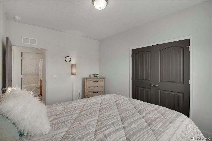 Bathroom featuring a garden tub, double vanity, a shower with door, and wood finished floors
