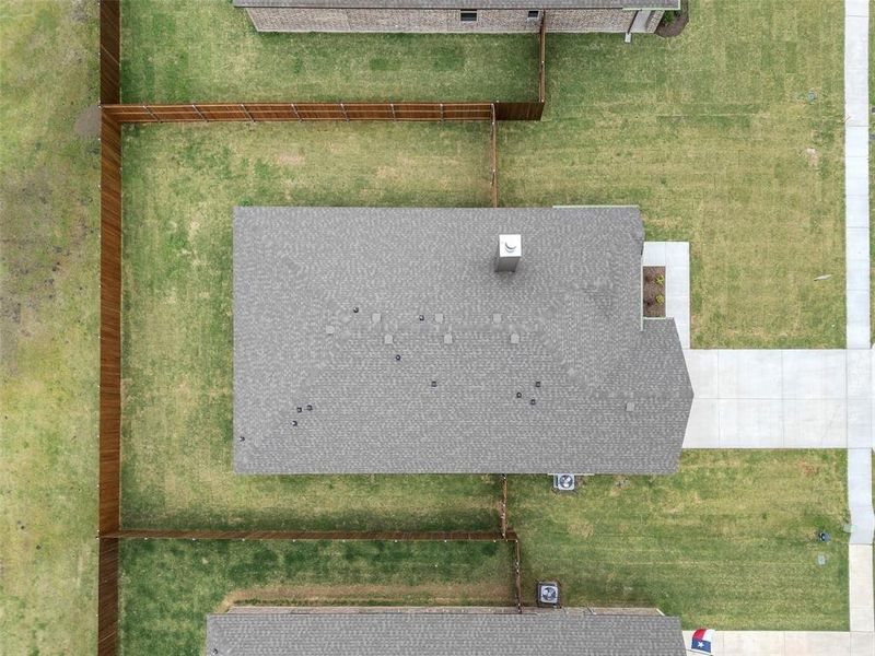 New construction featuring a composition shingle roof, chimney, and concrete drive