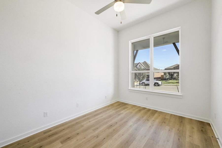 Unfurnished room featuring light wood finished floors and a ceiling fan Unfurnished room featuring light wood finished floors and a ceiling fan
