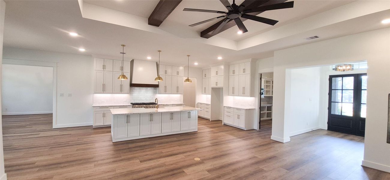 Looking back from Family Room towards Front Door and Kitchen with Large Island and Bar for Seating