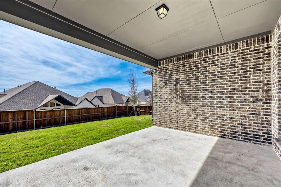 Fenced backyard featuring a patio area and a residential view