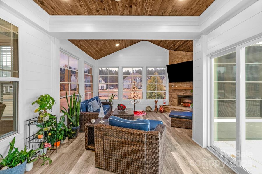 Climate controlled sunroom with electric fireplace and access to the Travertine pool deck