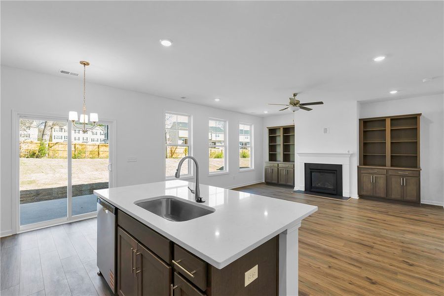 An open concept living area showcases a sleek kitc