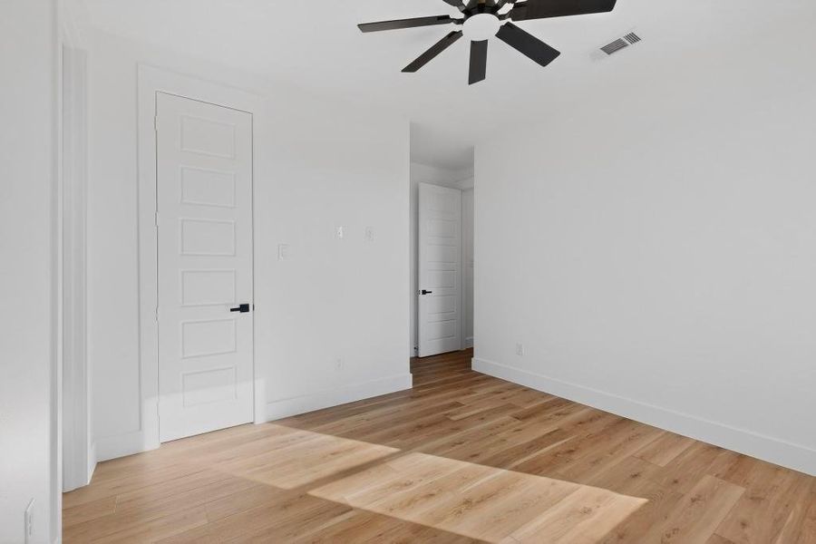 Unfurnished bedroom with light wood-style floors and ceiling fan Unfurnished bedroom with light wood-style floors and ceiling fan