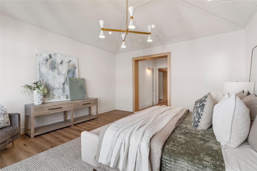 The elegant primary bedroom is just the refuge you need. A vaulted ceiling is made even more dramatic by the Albertine chandelier.