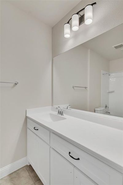 Bathroom with tile patterned floors, toilet, and vanity