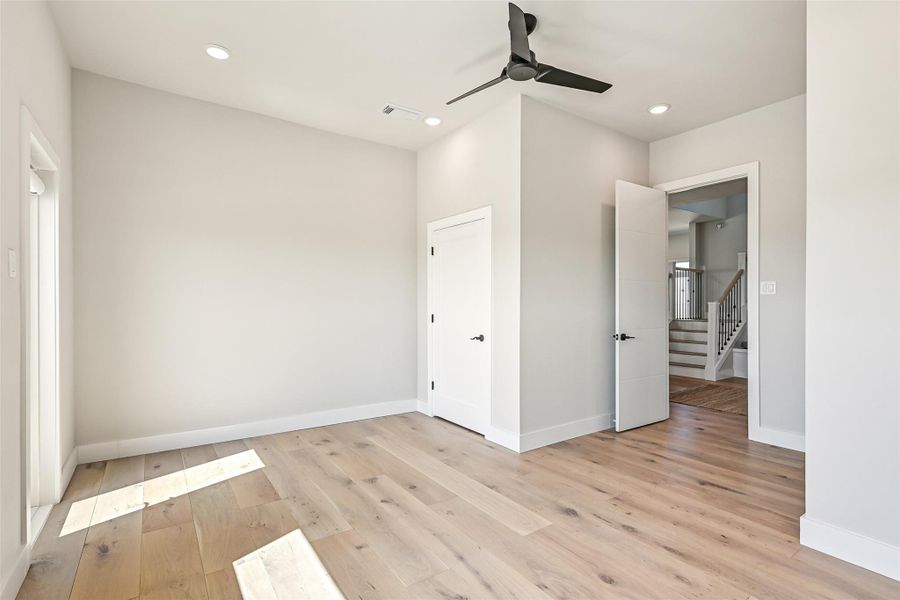 Conveniently located near the staircase, this room offers privacy while remaining connected to the heart of the home. Sunlight and clean architectural lines continue throughout the space.