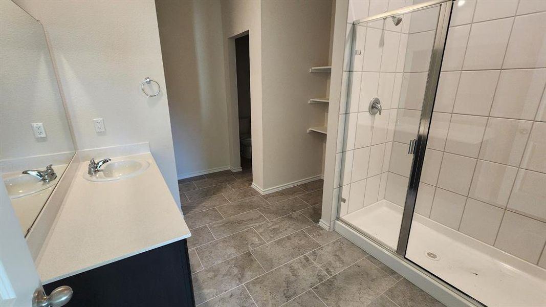 Contemporary bathroom featuring a single vanity with a white countertop, chrome faucet, and integrated sink Contemporary bathroom featuring a single vanity with a white countertop, chrome faucet, and integrated sink