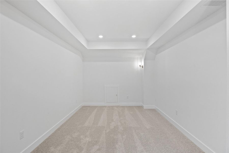 Unfurnished room with light colored carpet, recessed lighting, and a raised ceiling Unfurnished room with light colored carpet, recessed lighting, and a raised ceiling