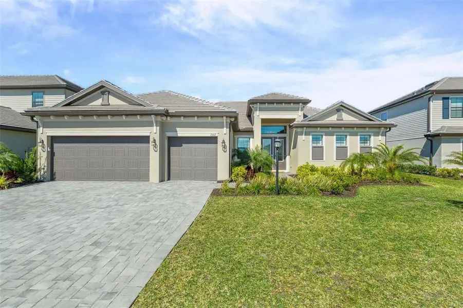 Front exterior of a new home in , Lakewood Ranch, FL, highlighting curb appeal (Image 24).