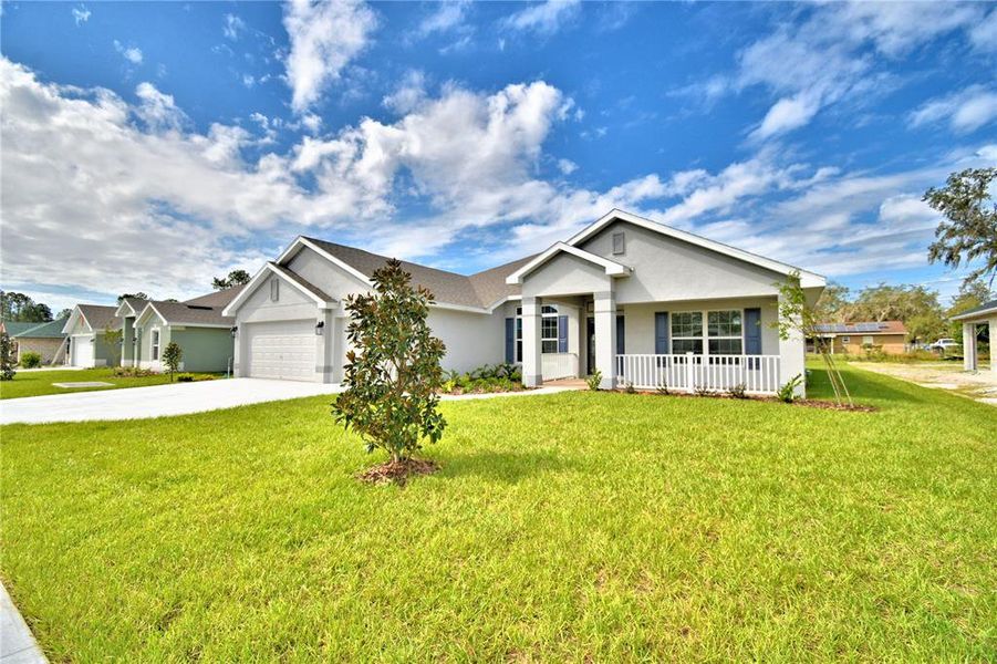 Front exterior of a new home in Cadence Crossing, Auburndale, FL, highlighting curb appeal (Image 2).