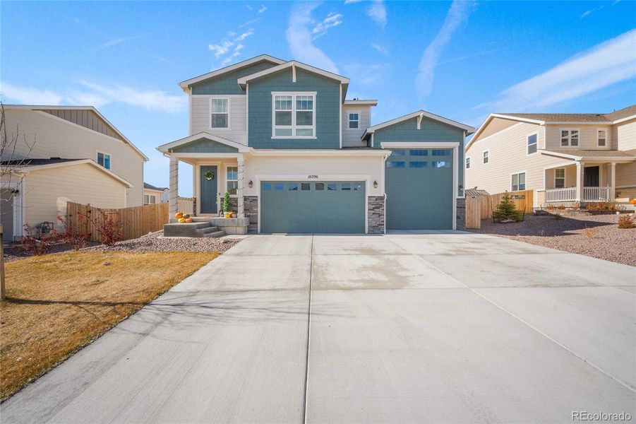 Front exterior of a new home in Paint Brush Hills, Peyton, CO, highlighting curb appeal (Image 27).