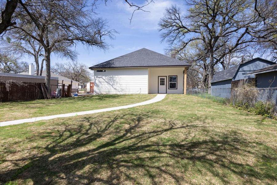 Back of property with roof with shingles  4403 N. Port Ridglea Ct. Granbury,TX 76049