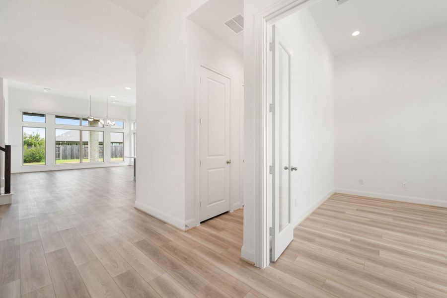 Right inside the front doorway you will find a dedicated home office, a half bathroom, and a coat closet.
