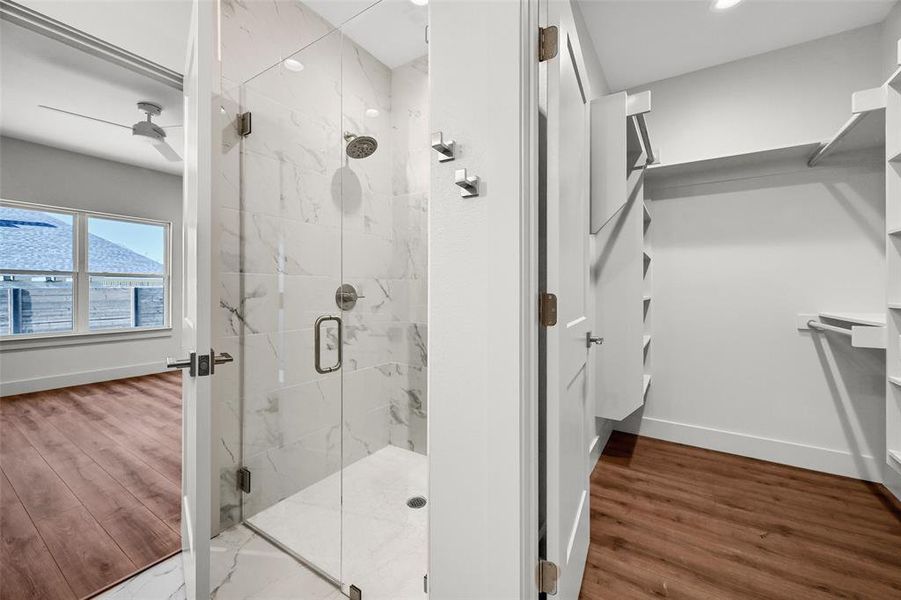 Features a walk-in shower and custom walk-in closet