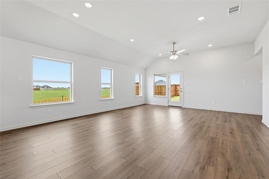 Empty room with vaulted ceiling, dark wood-style flooring, recessed lighting, and ceiling fan