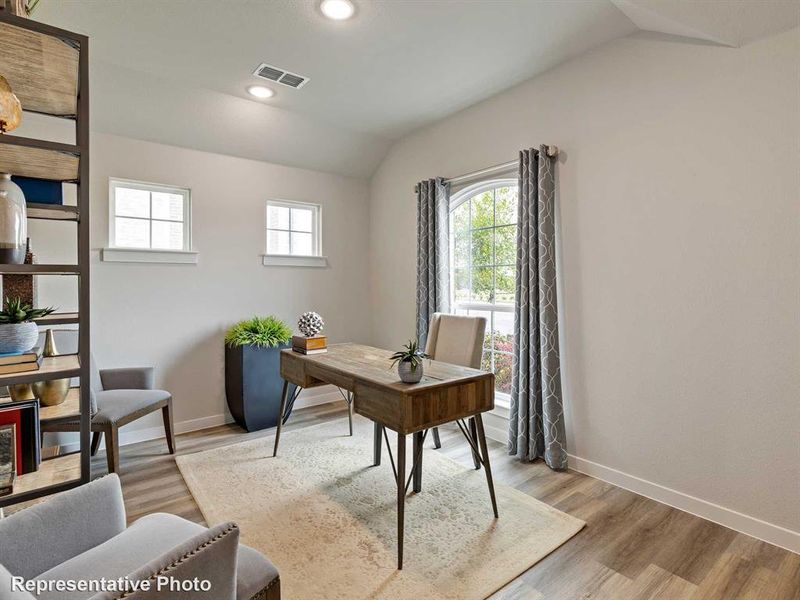 Office with vaulted ceiling and light hardwood / wood-style flooring