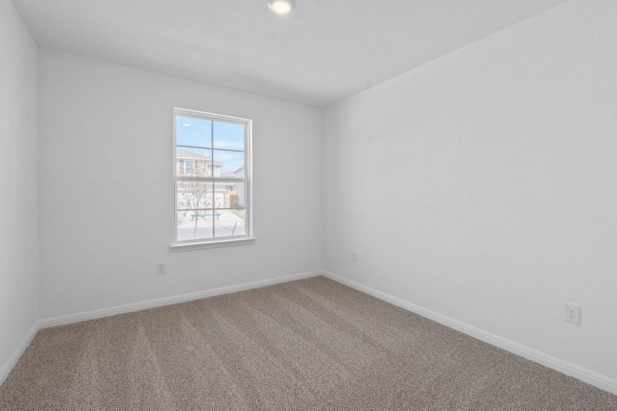 Carpeted empty room with baseboards