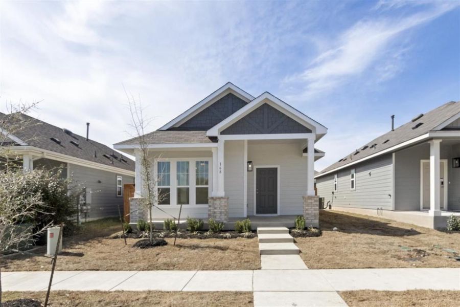 Front exterior of a new home in Trace, San Marcos, TX, highlighting curb appeal (Image 20).