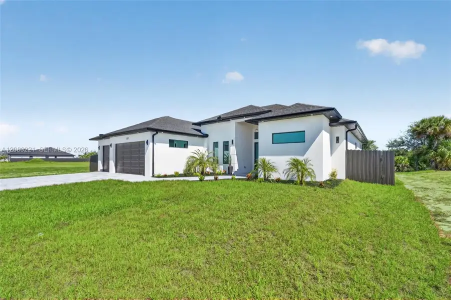 Front exterior of a new home in , Cape Coral, FL, highlighting curb appeal (Image 27). Front exterior of a new home in , Cape Coral, FL, highlighting curb appeal (Image 27).