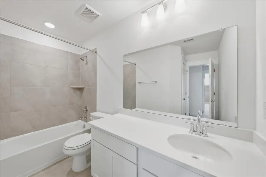 Bathroom with shower / washtub combination, vanity, recessed lighting, and light tile patterned flooring Bathroom with shower / washtub combination, vanity, recessed lighting, and light tile patterned flooring