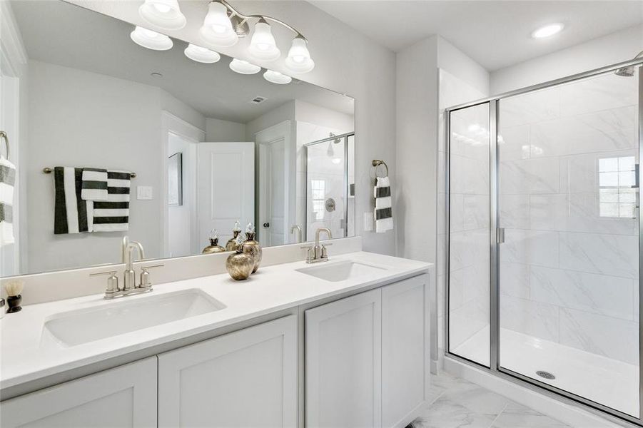 Bathroom featuring walk in shower and vanity