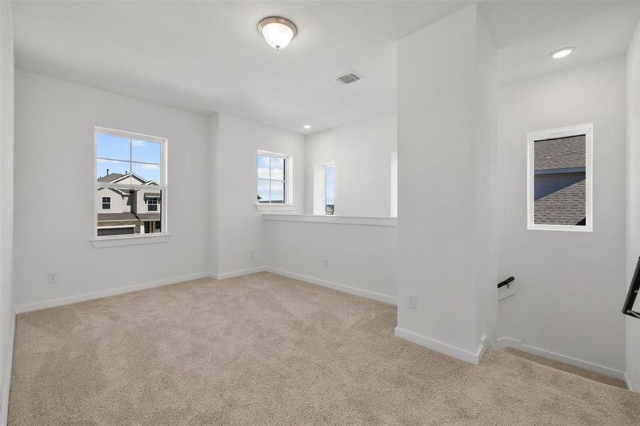 Spare room with plenty of natural light, light colored carpet, and recessed lighting Spare room with plenty of natural light, light colored carpet, and recessed lighting