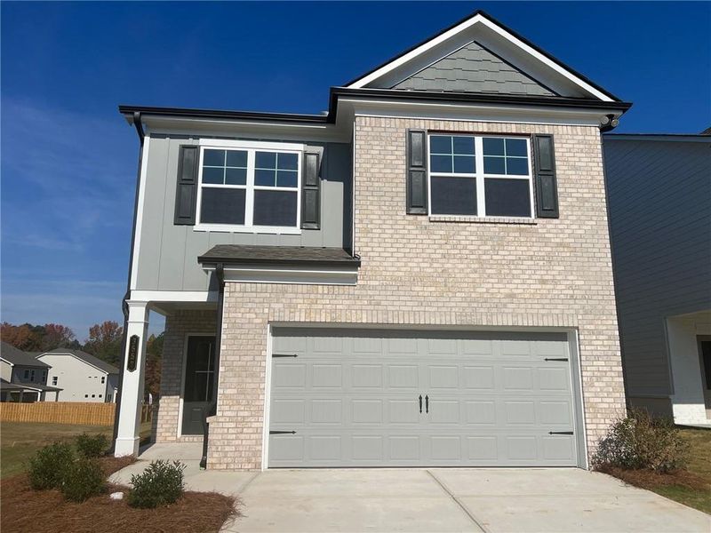 Front exterior of a new home in Crofton Place Enclave, Snellville, GA, highlighting curb appeal (Image 2). Front exterior of a new home in Crofton Place Enclave, Snellville, GA, highlighting curb appeal (Image 2).