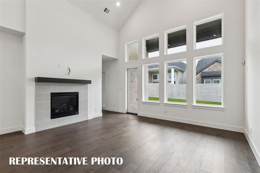 A wall of windows floods this wonderful family room with natural light!  REPRESENTATIVE PHOTO