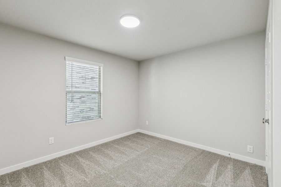 Bedroom in the Harper home plan by Trophy Signature Homes – REPRESENTATIVE PHOTO