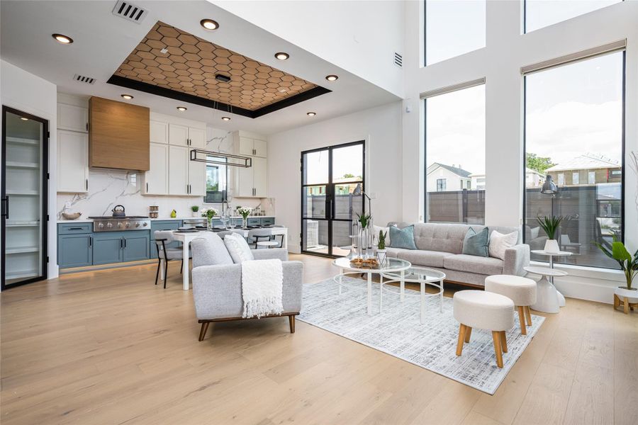 Soaring ceilings in the family room paired with a wall of 8-foot picture windows flood the space with light, delivering a showstopping “wow” factor Soaring ceilings in the family room paired with a wall of 8-foot picture windows flood the space with light, delivering a showstopping “wow” factor