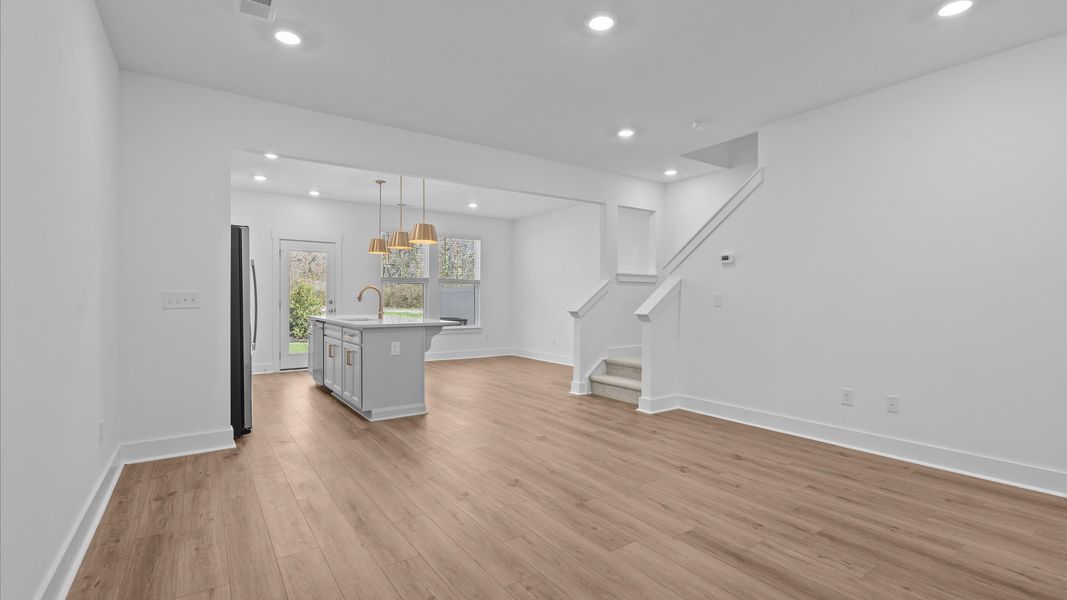 Exceptional family space with hardwood floors and seamless flow to dining and kitchen areas at Gresham Station