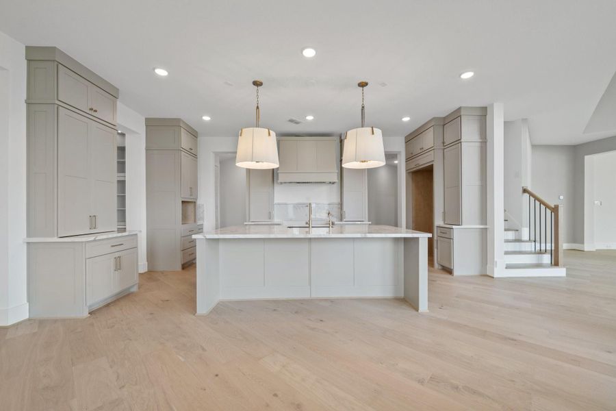 Kitchen with detailed finishes and large island, opens to the Breakfast Area and Family Room with French doors leading to the back patio perfect for entertaining indoors and out. Kitchen with detailed finishes and large island, opens to the Breakfast Area and Family Room with French doors leading to the back patio perfect for entertaining indoors and out.