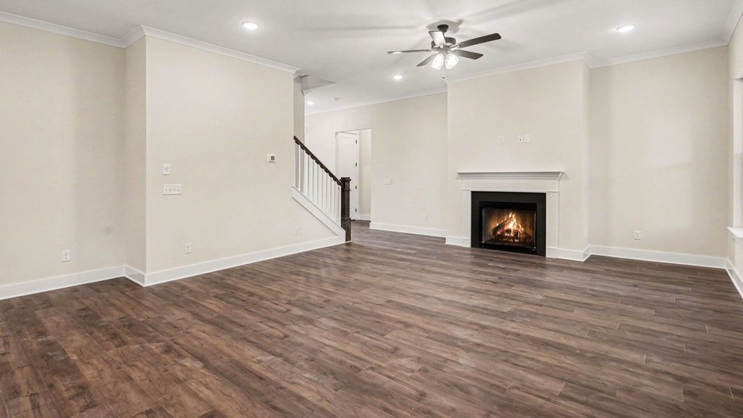 Gathering room with fireplace, ceiling fan, and hard surface flooring Gathering room with fireplace, ceiling fan, and hard surface flooring
