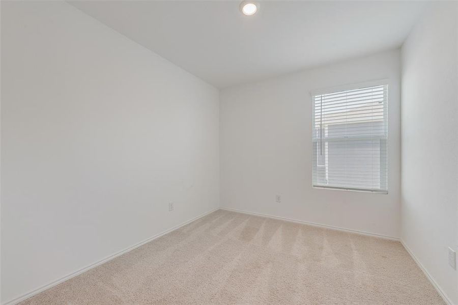 Empty room featuring light carpet and baseboards Empty room featuring light carpet and baseboards