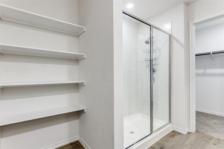 Glass-enclosed shower with chrome fixtures Glass-enclosed shower with chrome fixtures
