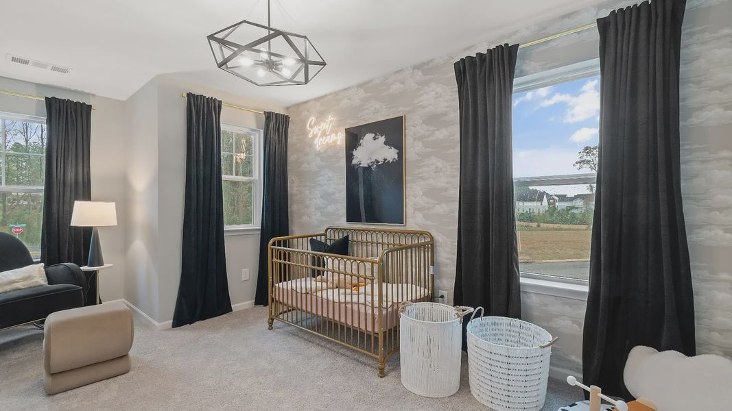 Kids bedroom with soft color scheme and many windows in new construction townhome in Riverdale, GA.
