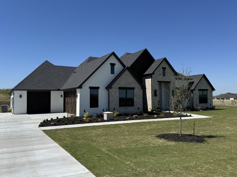 Front exterior of a new home in Summit Ranch, Aledo, TX, highlighting curb appeal (Image 1). Front exterior of a new home in Summit Ranch, Aledo, TX, highlighting curb appeal (Image 1).