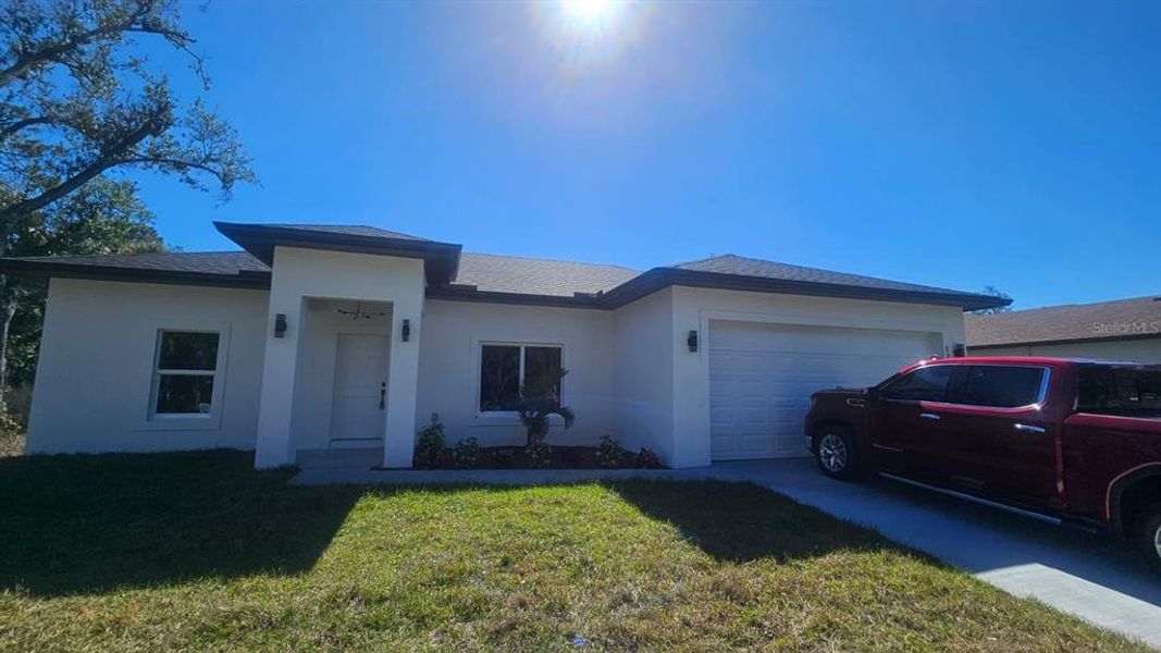 Front exterior of a new home in , Port Charlotte, FL, highlighting curb appeal (Image 1).